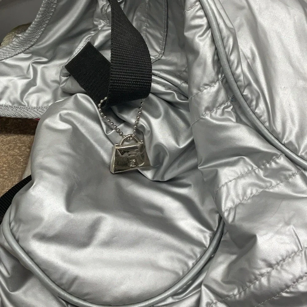Jeanne Lottie Metallic Silver Puffer Backpack Orange Lining Techwear Y2K Bag